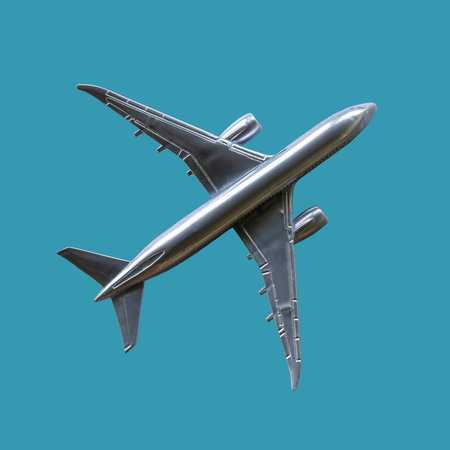 Silvery model airplane top view. The isolated object on a turquoise background. Air Transport....