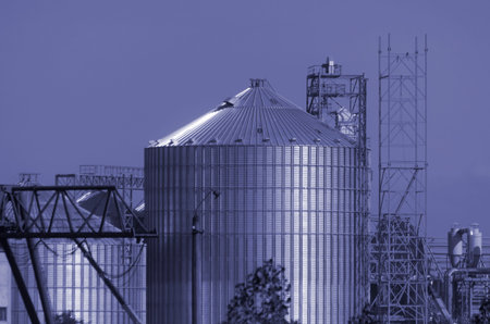 Construction of a modern grain terminal. Metal cylindrical silo and support metal structure for the...