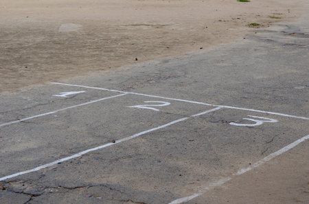 White lines and numbers 1, 2, 3 on the asphalt. Number of treadmills on the school playground....
