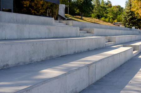 Abstract Geometric Concrete Background. Fragment of the arena with degrees in bright sunlight. Empty...