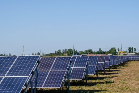 Rows of solar panels in a field. Solar power plant. Energy, technology.