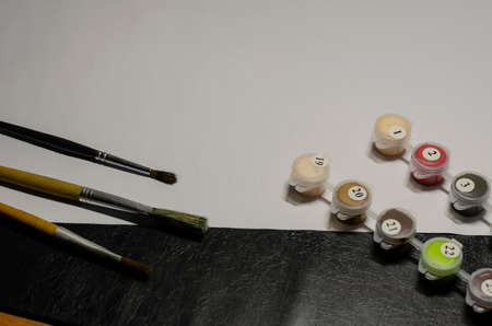 Drawing training, creative hobby, self-development concept. A group of brushes for painting and paint by numbers. An aspiring artist's kit.の写真素材