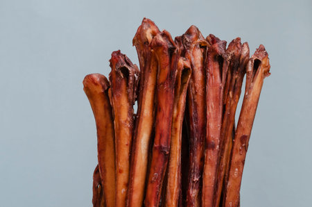 Air dried bull penises for dogs on a blue background. Group of natural chewing treats for dogs....