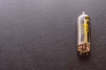 Mykolaiv, Ukraine - August 7, 2020: Tesla radio tube on dark background. Vintage radio lamp made in Czechoslovakia.のeditorial素材