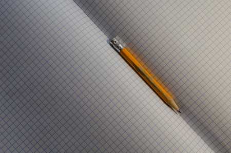 Engineering, accounting, business, education concept. Close-up of an old yellow wooden pencil on...