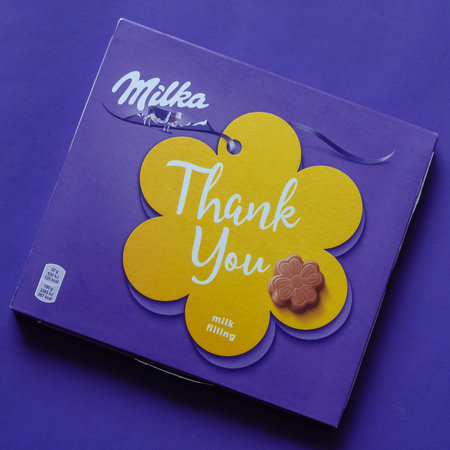 Milka "Thank you" chocolates. Box of Milka milk chocolate on a blue background. Nikolaev, Ukraine - January 3, 2021.のeditorial素材