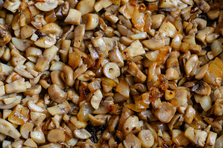 Roasted mushrooms with onions, detailed shot. Diced mushrooms fried in olive oil with onions. Food backgrounds.の写真素材