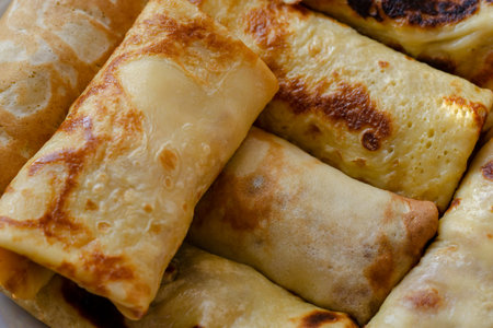 Blini, Shrovetide. Close-up of traditional homemade crepes stuffed with various fillings. Ready to...