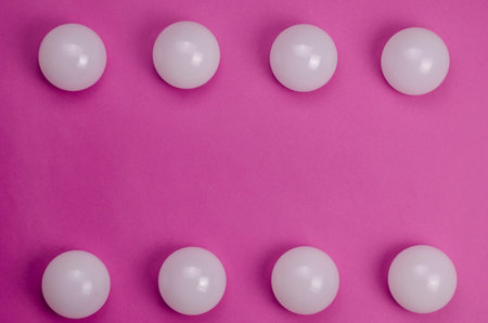Creative geometric composition with white spheres on a pink background. Eight spheres. Copy space....