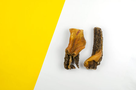 Natural dental treats for dogs. Chew Treats. Bovine stomach sticks. Dried beef tripe on white...