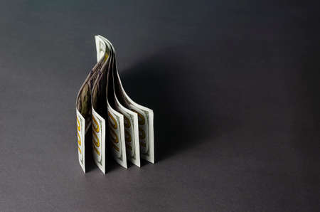 Creative abstract background with one hundred dollar bills with copy space. Five banknotes mounted vertically on a gray background. Close-up, selective focus.の写真素材