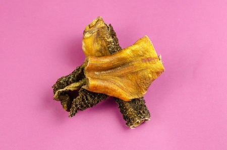 Natural healthy treats for dogs of premium quality. Dried beef stomach, buffalo tripe on a pink...