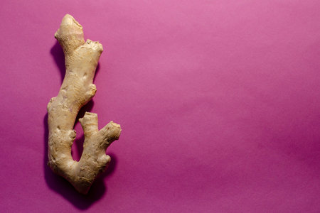 Alternative and folk medicine concept. Ginger root on a pink background. Top view, copy space,...