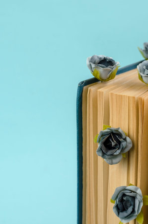 The old book is a hard blue cover with flowers between the pages. Small gray flowers. The book...