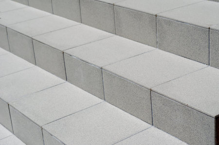 Brown staircase closeup. The steps are covered with ceramic tiles. Abstract geometric composition....