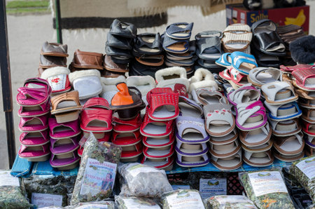 A counter with slippers and herbal teas for sale. Local street market. The inscriptions in Ukrainian mean the name of the herbal teas and their composition. Nikolaev, Ukraine - March 10, 2021のeditorial素材