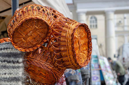 New wicker baskets in the street market. Easter or picnic baskets. Wicker products. Spring fair. Selective focus.の写真素材