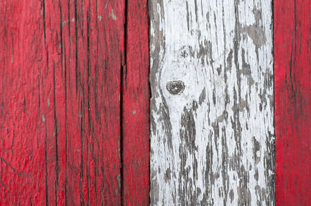 Three old wooden boards with cracked paint. Weathered white and red boards. Cracked wood texture. Abstract background.の写真素材