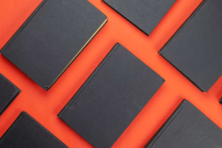 Concept of education, knowledge, wisdom. A group of identical hardcover books on a red background. Flat layの写真素材