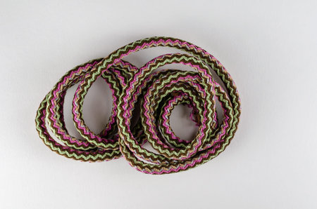 Universal polypropylene rope on a neutral background. A coil of new colored rope. View from above.