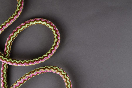 Versatile propylene rope on a gray background. Round Multicolored braided synthetic fiber rope with core. Top view, flatlay. Copy space.の写真素材