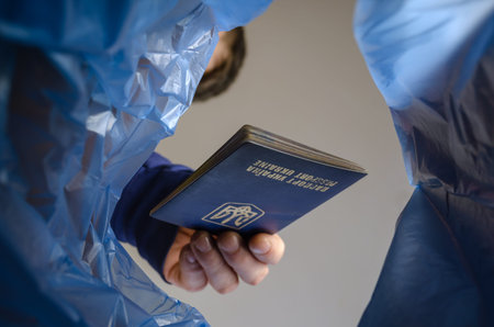 The hand throws the passport into the trash. Change of citizenship, political asylum, emigration,...
