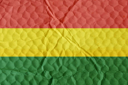 Yellow-green-red National Flag of Bolivia on an uneven textured surface. The concept of freedom, independence of the nation.の写真素材