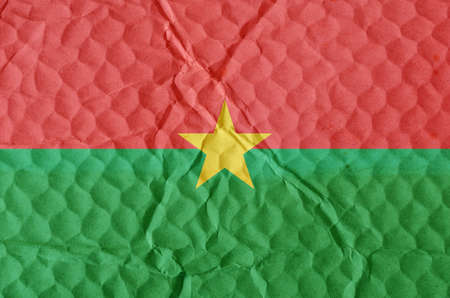 The national flag of Burkina Faso on an uneven textured surface. The concept of freedom, independence of the nation.の写真素材