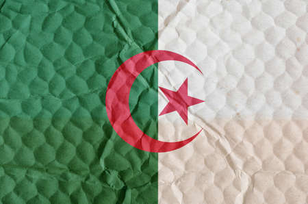 The national flag of Algeria on an uneven textured surface. Flag of the Algerian Democratic People's Republic. Concept of freedom, independence of the nation.の写真素材