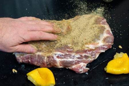 Homemade Capicola (coppa). Dry-cured pork loin step-by-step recipe. Hand rubbing spices over the...