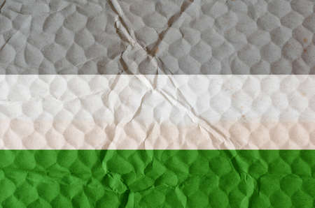 Three-color naturist flag on uneven textured surface. Concept of love, equality, freedom of choice, unity in diversity, beauty and joy.の写真素材