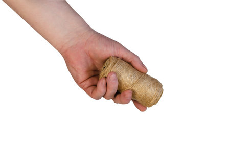 A man is holding a roll of twine. Hand with coiled twine isolated on white background.