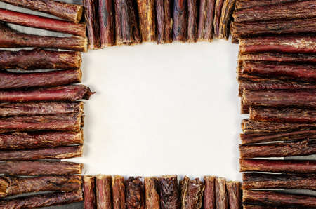 Dog treat sticks with a blank white space for text in the center. Dried beef esophagus. Natural chewy goodies for pets.の写真素材