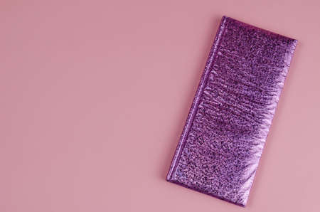 Pink female notebook on color background. Closed beautiful notebook on pink.の写真素材