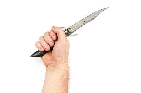 The handholds an old hunting knife made from a goat's hoof on the white background. Knife with a saw...