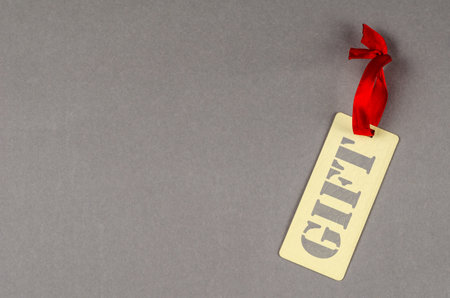 Concept of percentage label for sales promotion. Yellow textured sales tag on gray background. Paper...