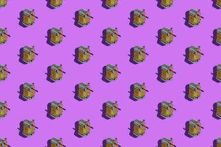 Repeated Wooden pencil and vintage sharpener on Lilac background. Manual metal tool for sharpening wooden pencils. Seamless pattern.の写真素材