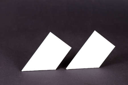 Abstract geometric composition of white quadrangles on a gray background. Two similar geometric shapes only with right and acute angles. Selective focus.の写真素材