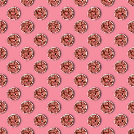 Repeated Ceramic bowl with raw marinated meat on pink background. Pieces of pork with salt, pepper and granulated garlic. Food, ingredients. Flat layの写真素材