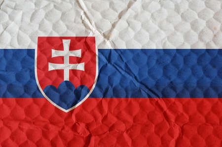 Flag of Slovak Republic on an uneven textured surface. The national flag of the country located in Central Europe. The concept of national pride, freedom, independenceの写真素材