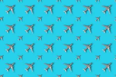 Soaring silver airplanes on a colored background. Repeating Children's toy plastic airplanes...