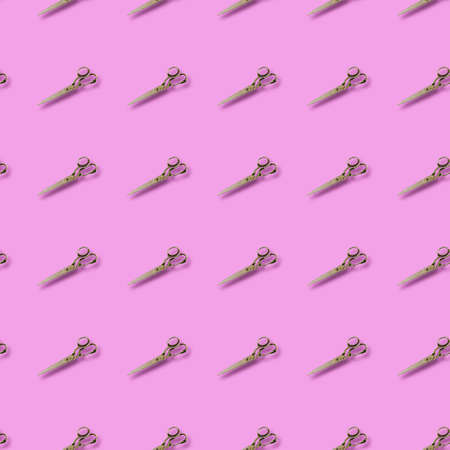 Repeated Old tailor scissors on a colored background. Vintage metal hand tools. Craft.の写真素材