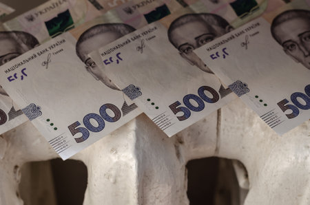 The money is on top of an old cast-iron heating radiator. Ukrainian five hundred hryvnia bills....