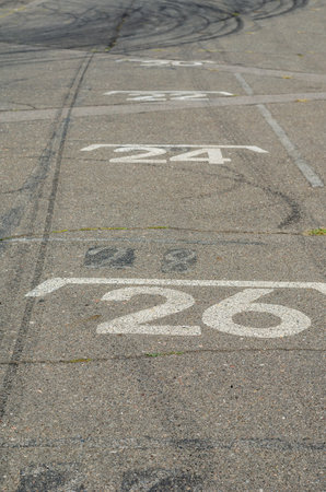 White numbers are painted on the pavement. Starting places for karts. Starting grid is the place for the karts to be built in the starting order. Go-kart track. Children's motorsport, competitionの写真素材