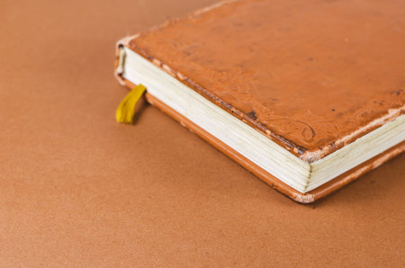 Close-up of a worn old notebook. A diary or planner with notes in a brown leather binder. Selective focus.の写真素材