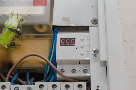 Voltage stabilizer. Digital display with red numbers. Electrics. Close-up. Inside the room....