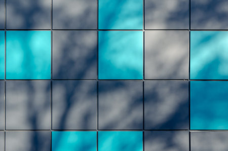 Gray and turquoise alternating squares. Abstract shadows on the exterior wall of the building. The...