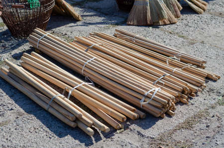 Farmer's Fair in the open air. New wooden handles for shovels. Millet brooms. street trade. selective focus.の写真素材
