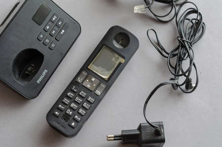 Philips D605 radiophone against a gray background. black cordless phone. Communication, technology. Ukraine, Kyiv - 01 31 2022のeditorial素材