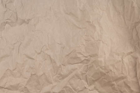 Beige abstract multitasking background. Crumpled bamag texture. Crumpled paper surface.の写真素材